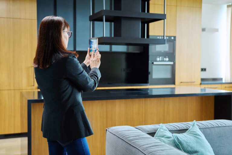 Woman real estate agent photographing furnished apartment