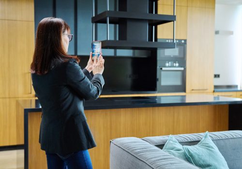 Woman real estate agent photographing furnished apartment